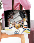 Personalized black tote bag with a golden retriever pet portrait in a hockey jersey holding a trophy.